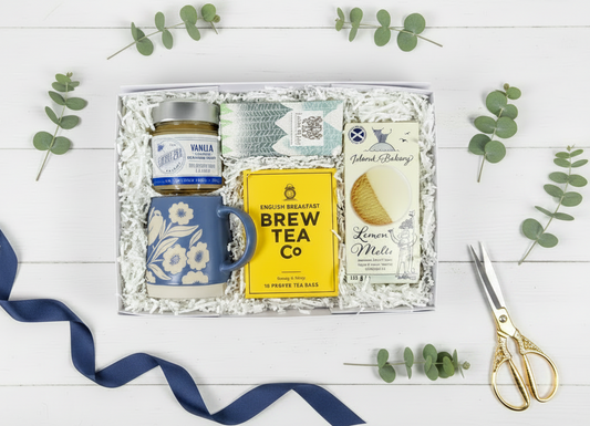 Tea gift box flatlay with gold scissors