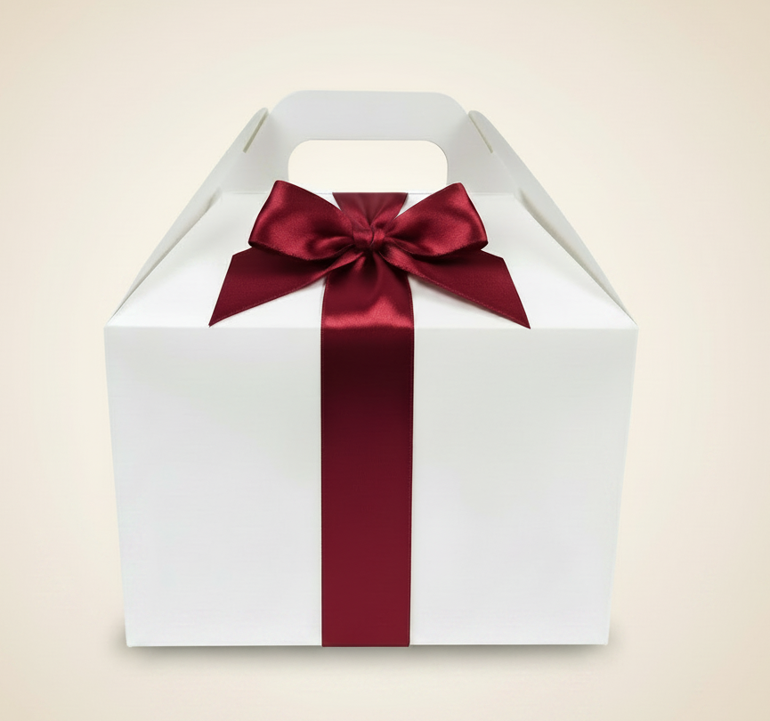 White gable box with deep red ribbon on light beige background